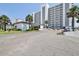 Exterior of beachfront condominium with palm trees, highlighting its curb appeal at 1155 Ocean Shore Blvd # 702, Ormond Beach, FL 32176