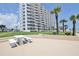 Condo building with lawn, ocean views, balconies, a grilling area and picnic tables at 1155 Ocean Shore Blvd # 702, Ormond Beach, FL 32176