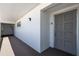 Well-maintained hallway leading to unit with neutral color palette and ample lighting at 1155 Ocean Shore Blvd # 702, Ormond Beach, FL 32176