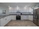 Fully equipped kitchen with white cabinetry, stainless steel appliances, and sleek countertops at 1155 Ocean Shore Blvd # 702, Ormond Beach, FL 32176
