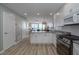 Modern kitchen with white cabinets, stainless steel appliances, and a view of the living area and ocean at 1155 Ocean Shore Blvd # 702, Ormond Beach, FL 32176