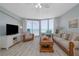Bright living room with ocean views, comfortable seating, and sliding glass doors to the balcony at 1155 Ocean Shore Blvd # 702, Ormond Beach, FL 32176