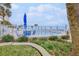 Ocean view of a gated pool area with lounge chairs and landscaping at 1155 Ocean Shore Blvd # 702, Ormond Beach, FL 32176