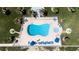 Aerial shot of a pristine kidney-shaped pool with ample lounge seating and tropical landscaping at 1155 Ocean Shore Blvd # 702, Ormond Beach, FL 32176