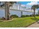 Landscaped entrance to Surfside Club North Condominium, featuring lush greenery and signage at 1155 Ocean Shore Blvd # 702, Ormond Beach, FL 32176