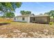 Back view of the house featuring a covered patio and backyard at 1197 Stillwood Ct, Port Orange, FL 32129