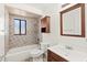 Bathroom featuring a bathtub, tiled walls, a sink with vanity, and a mirror at 1197 Stillwood Ct, Port Orange, FL 32129