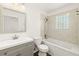 A bright bathroom with a bath/shower combination and a glass block window at 1197 Stillwood Ct, Port Orange, FL 32129