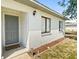 Welcoming front entrance with a gray door, manicured landscaping, and a 