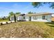 Well-manicured front lawn of single Gathering home, complemented by fresh landscaping and an attached garage at 1197 Stillwood Ct, Port Orange, FL 32129