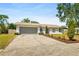 Charming single-story home with well-maintained lawn and driveway to an attached garage at 1197 Stillwood Ct, Port Orange, FL 32129