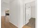 Hallway leading to bedroom and screened in patio, featuring hardwood floors at 1197 Stillwood Ct, Port Orange, FL 32129