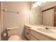 Bathroom with a white vanity, a large mirror, a toilet, and tiled floors at 140 Limewood Pl # 2, Ormond Beach, FL 32174