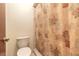 Standard bathroom featuring a toilet, shower with a floral curtain, and neutral walls at 140 Limewood Pl # 2, Ormond Beach, FL 32174