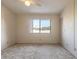 A bedroom featuring neutral carpet, walls, a ceiling fan and a view from the window at 140 Limewood Pl # 2, Ormond Beach, FL 32174