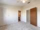 Bedroom with neutral walls, carpet and ceiling fan, with two closet doors and an entry to bathroom at 140 Limewood Pl # 2, Ormond Beach, FL 32174