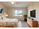 Bright bedroom with a large window offering scenic views, stylish furniture, and ample closet space at 140 Limewood Pl # 2, Ormond Beach, FL 32174