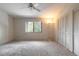 Bright bedroom featuring a ceiling fan, large window, neutral carpet and paint, and ample closet space at 140 Limewood Pl # 2, Ormond Beach, FL 32174