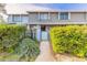Inviting townhome entrance with a well-manicured hedge and partially enclosed courtyard at 140 Limewood Pl # 2, Ormond Beach, FL 32174