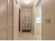 Bright hallway with tiled floor and closet, leading to the front door at 140 Limewood Pl # 2, Ormond Beach, FL 32174