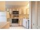 Functional kitchen featuring white cabinets, standard appliances, and tile flooring at 140 Limewood Pl # 2, Ormond Beach, FL 32174