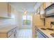 Bright kitchen with white appliances, ample counter space, and garden view at 140 Limewood Pl # 2, Ormond Beach, FL 32174