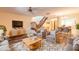 Bright and airy living room with a stylish rug, comfortable seating, and an open staircase at 140 Limewood Pl # 2, Ormond Beach, FL 32174