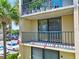 Exterior balcony area with railing, potted plants, and parking area in view at 1441 N Atlantic Ave # 211, Daytona Beach, FL 32118