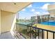Balcony overlooking a tennis court and complex amenities under a partly cloudy sky at 1441 N Atlantic Ave # 211, Daytona Beach, FL 32118