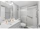 Clean and functional bathroom with a shower featuring a glass sliding door, and vanity with ample space at 1441 N Atlantic Ave # 211, Daytona Beach, FL 32118