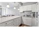 Updated kitchen featuring stone countertops, white cabinets and stainless steel sink at 1441 N Atlantic Ave # 211, Daytona Beach, FL 32118