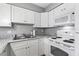 Modern kitchen with white cabinetry, granite countertops, and stainless-steel appliances at 1441 N Atlantic Ave # 211, Daytona Beach, FL 32118