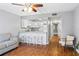 Open living area with wood floors, and kitchen with a white bar and seating at 1441 N Atlantic Ave # 211, Daytona Beach, FL 32118