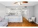 Open living area with wood floors, and kitchen with a white bar and seating at 1441 N Atlantic Ave # 211, Daytona Beach, FL 32118
