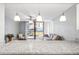 Bright living room features granite counters, modern lighting, and a sliding door to the balcony with pool view at 1441 N Atlantic Ave # 211, Daytona Beach, FL 32118