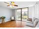 Bright living room with wood floors, sofa, and sliding doors to balcony at 1441 N Atlantic Ave # 211, Daytona Beach, FL 32118