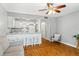 Open living area with wood floors, and kitchen with a white bar and seating at 1441 N Atlantic Ave # 211, Daytona Beach, FL 32118