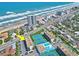 Stunning aerial view of the beachfront property with tennis courts and swimming pool and ample parking at 1441 N Atlantic Ave # 417, Daytona Beach, FL 32118