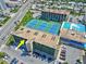 Aerial view showing the building, tennis courts, pool, parking, and surrounding neighborhood at 1441 N Atlantic Ave # 417, Daytona Beach, FL 32118