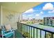 Relaxing balcony view with chairs, road, buildings, and sunny skies and tennis courts at 1441 N Atlantic Ave # 417, Daytona Beach, FL 32118