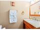 Cozy bathroom featuring a granite-topped vanity, decorative towels, and neutral decor at 1441 N Atlantic Ave # 417, Daytona Beach, FL 32118