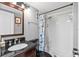 Well-lit bathroom featuring a shower, granite vanity and sink, and a decorative shower curtain at 1441 N Atlantic Ave # 417, Daytona Beach, FL 32118