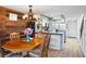 Charming dining room next to kitchen, featuring a wooden table and stairs leading to upper level at 1441 N Atlantic Ave # 417, Daytona Beach, FL 32118