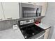 This kitchen showcases stainless steel appliances with microwave above the range and a stylish backsplash at 1441 N Atlantic Ave # 417, Daytona Beach, FL 32118