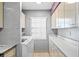 Laundry room features modern washer, dryer, and ample storage cabinets with a sleek design at 1441 N Atlantic Ave # 417, Daytona Beach, FL 32118