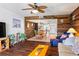 Open-concept living room featuring hardwood floors, wood accent wall, and easy access to kitchen at 1441 N Atlantic Ave # 417, Daytona Beach, FL 32118