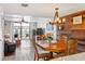 Bright living area with wood accent walls, dining area, and access to outdoor balcony at 1441 N Atlantic Ave # 417, Daytona Beach, FL 32118