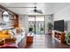 Inviting living room with hardwood floors, comfy seating, and a large sliding door to a private balcony at 1441 N Atlantic Ave # 417, Daytona Beach, FL 32118