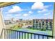 Balcony view of tennis courts, road, buildings and blue skies with white clouds at 1441 N Atlantic Ave # 417, Daytona Beach, FL 32118