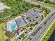 Aerial view showcasing the community center's swimming pool, pickleball courts, parking, landscaping, and road access at 1689 Lake Reserve Dr, Deland, FL 32724